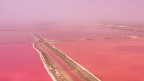 Beautiful-aerial-over-bright-red-and-pink-salt-pan-farms-near-Walvis-Bay-Namibia-4