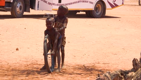 Poor-African-children-play-with-a-bicycle-wheel-as-a-toy-in-a-Himba-village-on-the-Namibia-Angola-border