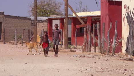 Small-children-walk-through-an-African-village-in-Damaraland-Namibia-Africa