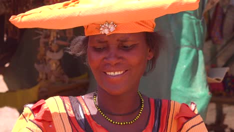 Beautiful-shot-of-Herero-African-tribal-woman-in-bright-fashion-costumes-at-a-marketplace-in-Namibia-Africa