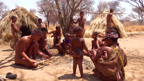 African-San-tribal-bushmen-family-at-their-huts-in-a-small-primitive-village-in-Namibia-Africa-1