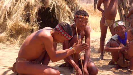 African-San-tribal-bushmen-make-fire-the-traditional-way-in-a-small-primitive-village-in-Namibia-Africa