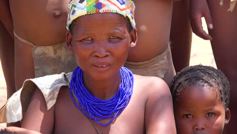 A-baby-breastfeeding-from-its-mother-in-a-small-primitive-African-San-tribal-village-in-Namibia-Africa