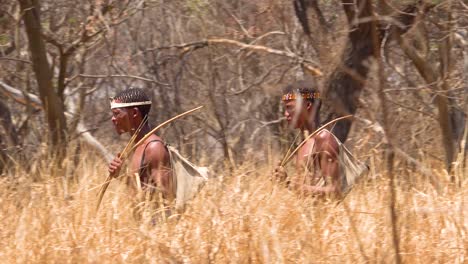 San-tribal-bushman-hunters-in-Namibia-Africa-walk-quiety-sniff-the-air-and-sample-the-soil-for-wind-direction-hunting-for-prey-2