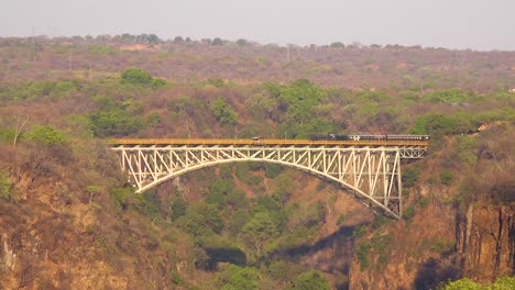 A-steam-passenger-train-crosses-a-bridge-near-Victoria-Falls-Zimbawbwe-or-Zambia-Africa-1