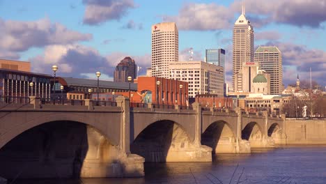 Beautiful-establishing-shot-of-Indianapolis-Indiana-with-bridge-and-the-White-River-foreground