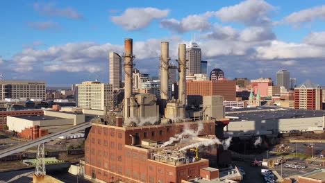 Nice-drone-aerial-of-downtown-Indianapolis-Indiana-with-industrial-factory-in-foreground-4