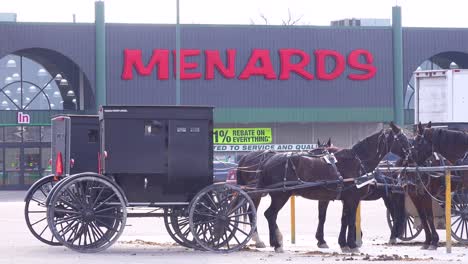Amish-horse-and-buggy-carriages-sit-outside-a-Menard's-home-improvement-superstore