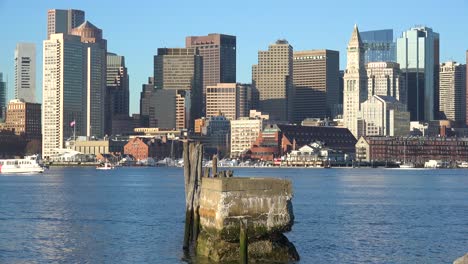 Establishing-shot-of-skyline-of-downtown-Boston-Massachusetts-business-district-with-water-taxis-passing