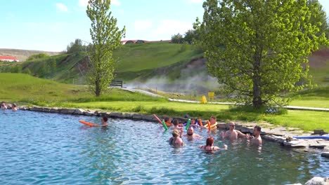 Tourists-and-Icelanders-enjoy-a-bath-in-a-hot-water-geothermal-spring-in-iceland-at-Fludir-Secret-Lagoon