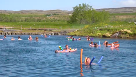Tourists-and-Icelanders-enjoy-a-bath-in-a-hot-water-geothermal-spring-in-iceland-at-Fludir-Secret-Lagoon-2