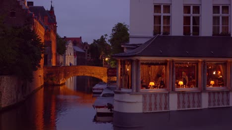 An-elegant-fancy-restaurant-along-a-beautiful-canal-in-Europe-Bruges-Belgium-night