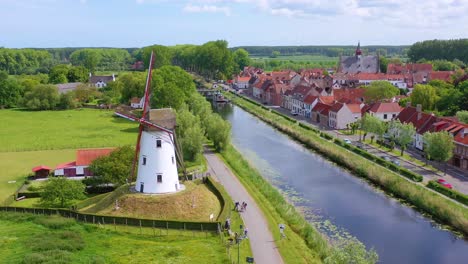 Aerial-over-canal-and-small-town-of-Damme-Belgium-and-historic-windmill-1