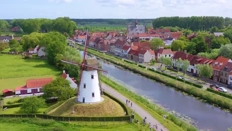 Aerial-over-canal-and-small-town-of-Damme-Belgium-and-historic-windmill-3