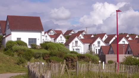 Rows-of-identical-beach-houses-cpottages-or-rental-cabins-along-the-coast-of-Normandy-France