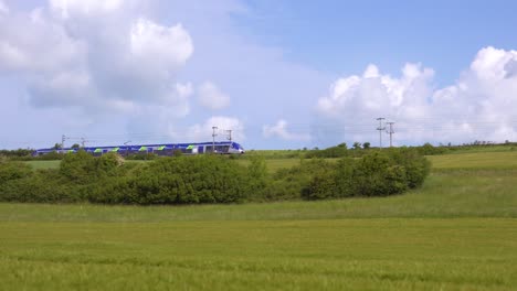 A-high-speed-electric-local-passenger-train-passes-through-the-countryside-of-Normandy-France