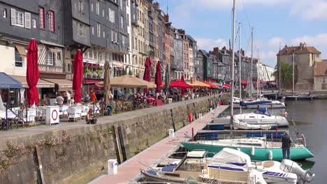 Beautiful-establishing-of-Honfleur-France-with-old-colorful-buildings-yachts-sailboats-in-harbor-and-cafes-3