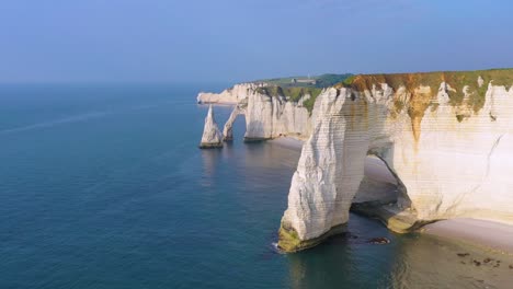 Nice-aerial-around-white-limestone-cliffs-and-arches-at-Etretat-France-English-Channel
