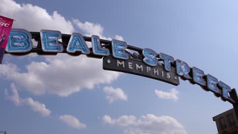 Time-lapse-shot-of-clouds-moving-behind-Beale-Street-Memphis-arch-sign-entertainment-district
