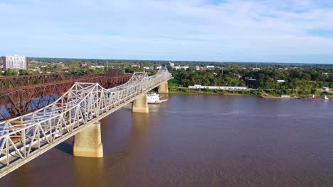Good-aerial-over-a-Mississippi-River-paddlewheel-steamship-going-under-three-steel-bridges-near-Memphis-Tennessee