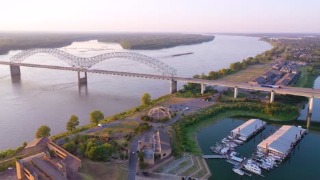 Good-aerial-over-a-barge-on-the-Mississippi-River-with-Hernando-de-Soto-Bridge-foreground