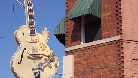 Establishing-shot-of-Sam-Phillips-Sun-Recording-studio-with-guitar-hanging-outside-in-Memphis-Tennessee-1