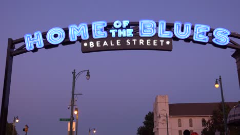 Nacht--Oder-Dämmerungsaufnahme-Des-Beale-Street-Memphis-Arch-Sign-Unterhaltungsviertels-Mit-Ankommenden-Touristen
