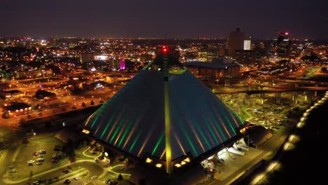 Beautiful-night-aerial-shot-of-the-Memphis-pyramid-Hernando-De-Soto-Bridge-and-downtown-Memphis-cityscape-at-dusk