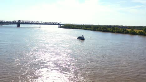 Good-aerial-of-a-paddlewheel-steamboat-riverboat-moving-up-the-Mississippi-River-with-Memphis-Tennessee-in-the-background-1