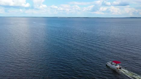 Aerial-of-a-pontoon-pleasure-fishing-boat-traveling-on-Ross-R-Barnett-Reservoir-near-Old-Trace-Park-Jackson-Mississippi