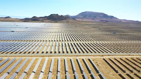 Side-view-drone-aerial-of-vast-solar-array-in-Mojave-Desert-California-suggests-clean-renewable-green-energy-resources
