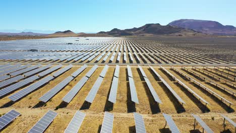 Forward-drone-aerial-of-vast-solar-array-in-Mojave-Desert-California-suggests-clean-renewable-green-energy-resources