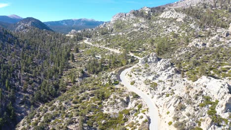 Aerial-over-a-winding-mountain-road-along-a-ridge-in-the-Eastern-Sierra-mountains-near-Lone-PIne-and-the-Owens-Valley-california