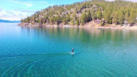 2020---a-man-rides-a-hydrofoil-efoil-electronic-surfboard-across-Lake-Tahoe-California-in-an-extreme-hydrofoiling-foil-sport-demonstration