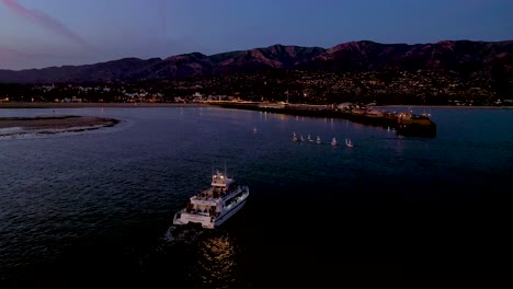 2020---night-dusk-or-twilight-aerial-over-a-fishing-boat-entering-Santa-Barbara-harbor