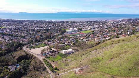 2020---aerial-over-the-pacific-coastal-green-hills-and-mountains-behind-Ventura-California-including-suburban-homes-and-neighborhoods-3