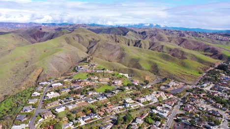 2020---aerial-over-the-pacific-coastal-green-hills-and-mountains-behind-Ventura-California-including-suburban-homes-and-neighborhoods-5