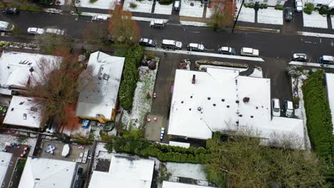 Top-down-aerial-over-snowy-winter-neighborhood-houses-suburbs-in-snow-in-Portland-Oregon