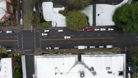 Top-down-aerial-over-snowy-streets-and-cars-in-suburbs-in-snow-in-Portland-Oregon-1
