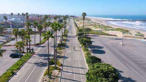 2020---aerial-of-lonely-biker-on-abandoned-roads-beaches-of-Ventura-southern-california-during-covid-19-coronavirus-epidemic-as-people-stay-home-en-masse