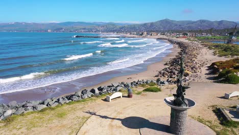 2020---aerial-of-mermaid-statue-and-abandoned-beaches-of-Ventura-southern-california-during-covid-19-coronavirus-epidemic-as-people-stay-home-en-masse