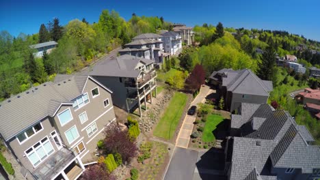 An-aerial-image-over-a-typical-american-suburban-street-and-condos-with-a-car-arriving-home