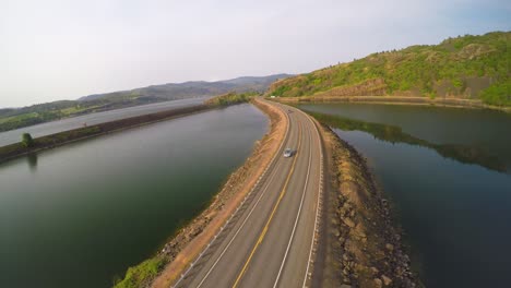 An-aerial-shot-of-cars-on-a-highway-crossing-a-lake-or-reservoir