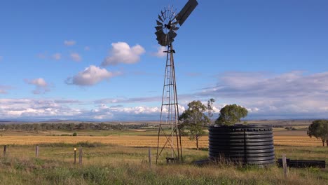 Establishing-shot-of-Australian-countryside-and-famland-near-Darlington-Downs-Allora-Queensland-with-weathervane-windmill