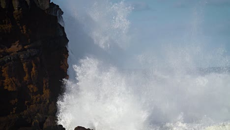Large-waves-roll-into-the-coast-of-Hawaii-in-slow-motion-and-break-along-a-craggy-coast-1