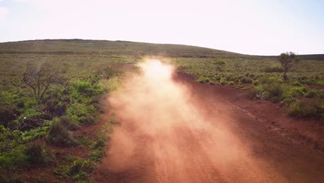 A-silver-Jeep-drives-fast-along-a-red-dirt-road-on-the-island-of-Lanai-in-Hawaii-1