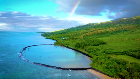 Aerial-over-Kahina-Pohaku-fish-pond-along-coast-of-Maui-Hawaii-with-rainbow