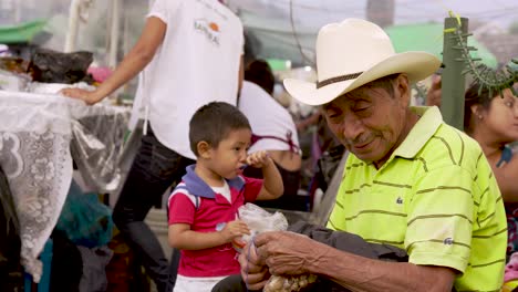 A-colorful-looking-old-Guatemalan-man-eats-at-a-local-food-stall-market