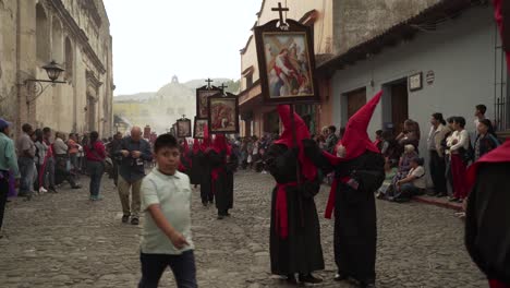 Purple-robed-priests-carry-religious-placards--in-a-colorful-Christian-Easter-celebration-in-Antigua-Guatemala