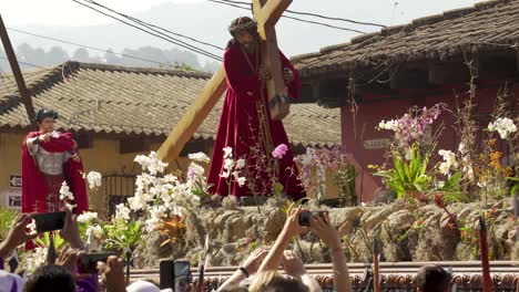 Women-carry-giant-statues-of-Jesus-and-the-cross-in-a-colorful-Christian-Easter-celebration-in-Antigua-Guatemala